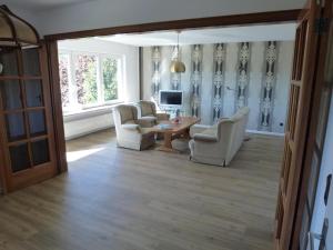 a living room with chairs and a table and a television at Ferienwohnung Hermann Miß in Bad Berleburg