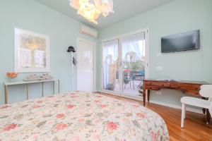 a bedroom with a bed and a desk and a window at Charme a Bergamo in Bergamo