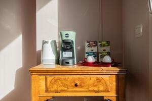 a coffee maker on top of a wooden table at Charme a Bergamo in Bergamo