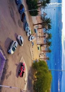 a group of parked cars parked on a beach at Larain Plaza Hotel in Aqaba