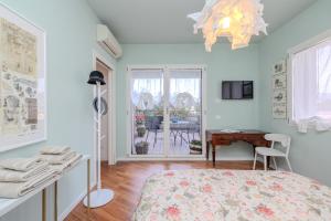 a bedroom with a bed and a desk and a window at Charme a Bergamo in Bergamo