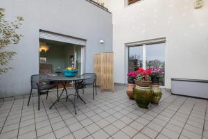a patio with a table and chairs and flowers at Charme a Bergamo in Bergamo +26 photos