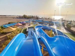 a blue water slide at a water park at Larain Plaza Hotel in Aqaba +3 photos