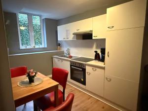 a kitchen with a table and a dining room at Flensburg Zentrum 69 01 in Flensburg