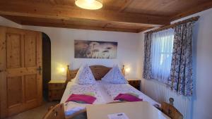 a bedroom with a bed with pillows on it at Stefflhof Mittersill in Mittersill