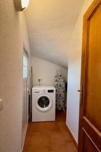 a washer and dryer in a small room at Villas Serena in Cala Blanca +9 photos
