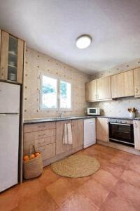 a kitchen with wooden cabinets and a counter top at Villas Serena in Cala Blanca