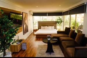 a living room with a bed and a couch at The Lekki Retreat in Lekki