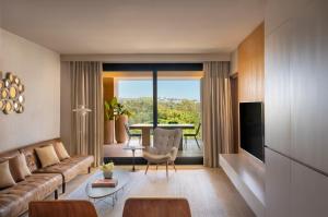 a living room with a couch and a table at Don Carlos Marbella in Marbella