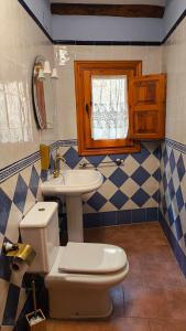 a bathroom with a toilet and a sink at Casa Mola in Forcall