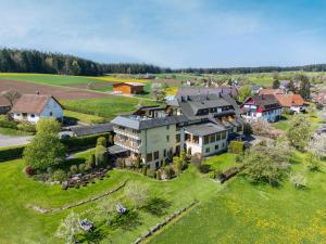 an aerial view of a large house on a green field at Landhotel Talblick in Neuweiler