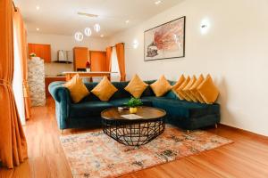 a living room with a green couch and a table at The Lekki Retreat in Lekki