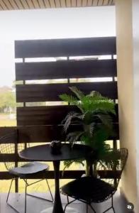 a table and chairs with a plant on a patio at The Lekki Retreat in Lekki