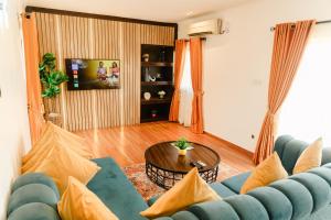 a living room with a blue couch and a table at The Lekki Retreat in Lekki