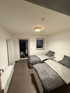 a bedroom with two beds and a window at AM Apartment 8 in Gronau