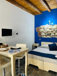 a bedroom with a bed and a desk and a table at CQ Rooms Verona in Verona