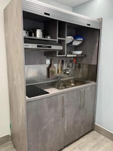 a stainless steel kitchen with a sink and a counter at Kyano Studios-Sotiria studios in Limenaria +23 photos