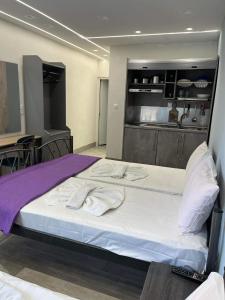 a large bed with towels on it in a kitchen at Kyano Studios-Sotiria studios in Limenaria