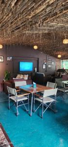 a room with a table and chairs and a couch at Kizumba House in Arusha