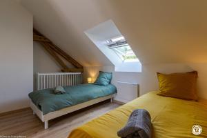 a bedroom with two beds in a attic at Gîte de Savenay in Aunay-en-Bazois