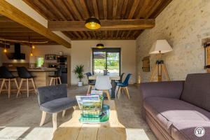 a living room with a couch and a table at Gîte de Savenay in Aunay-en-Bazois