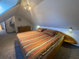 a bedroom with a bed with a surfboard on the wall at Gästehaus Siebert in Lobbe