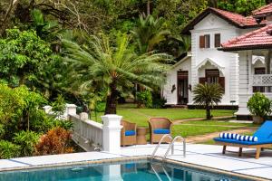 a swimming pool in front of a house at Clingendael Weligama in Weligama