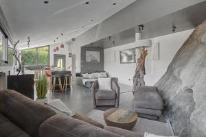 a living room with a couch and a table at La Roche & Le Lac in Sévrier