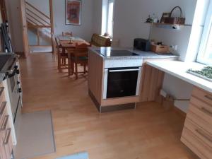 a kitchen with a sink and a stove top oven at Neue Wohnung am Fluss in Losenstein +2 photos