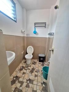 a bathroom with a toilet and a sink at Blessed Inn Annex in El Nido