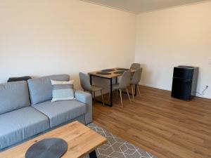 a living room with a couch and a table at Stadtwohnung Bocholt in Bocholt