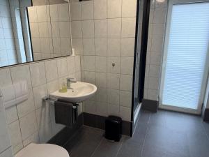 a bathroom with a sink and a toilet at Stadtwohnung Bocholt in Bocholt