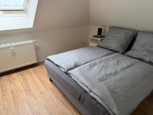 a bedroom with a large bed with a wooden floor at Stadtwohnung Bocholt in Bocholt