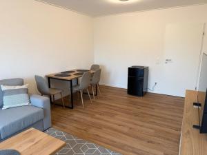 a living room with a couch and a table and chairs at Stadtwohnung Bocholt in Bocholt +14 photos