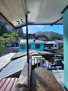 a view from the roof of a house with a table and chairs at Blessed Inn Annex in El Nido