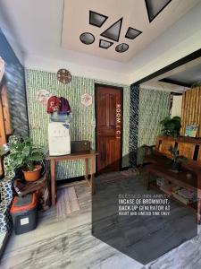 a room with a desk and a wooden door at Blessed Inn Annex in El Nido