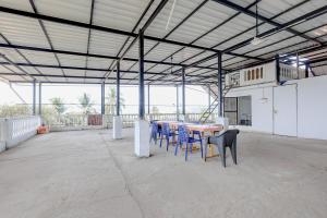 a large room with a table and chairs in it at FabHotel Crystal Bay Baga in Baga