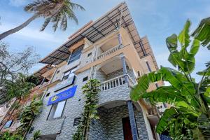a building with a blue sign on it at FabHotel Crystal Bay Baga in Baga