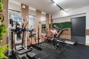 a gym with three exercise bikes and a treadmill at Rezydencja Wind Rose Luxury ApartHotel Gdańsk - Prywatne SPA in Gdańsk +71 photos