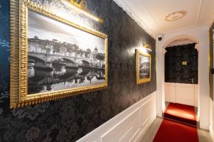 a hallway with a painting of a bridge on the wall at Lary's - San Pietro in Rome