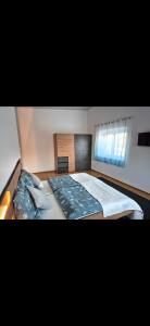 a bedroom with a large bed and a window at Gästezimmer Mürztal in Langenwang Schwöbing +1 photo