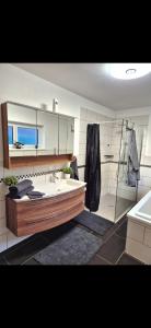 a bathroom with a tub and a sink and a mirror at Gästezimmer Mürztal in Langenwang Schwöbing