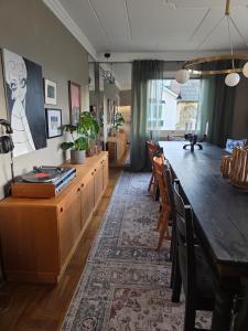 a living room with a long table and chairs at Stora Tegelhuset in Borlänge