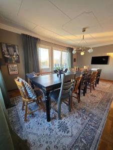 a dining room with a long table and chairs at Stora Tegelhuset in Borlänge