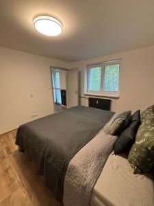 a bedroom with a large bed and a large window at Hrabůvka Living in Ostrava