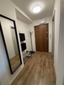 a hallway with a large mirror and a door at Hrabůvka Living in Ostrava