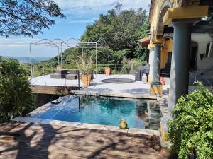 a swimming pool in the yard of a house at Le Chemin Guesthouse - 6 sleeper in Kloof
