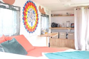 a room with a bed and a table in a room at Caravane cocooning in Saint-Martin-des-Noyers