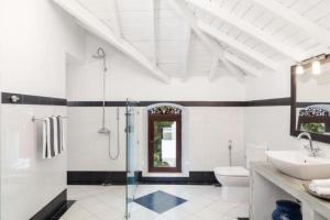 a bathroom with a shower and a toilet and a sink at Clingendael Weligama in Weligama +57 photos