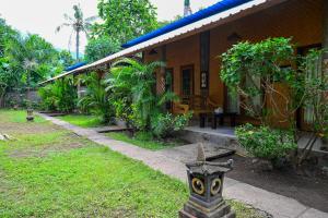 a house with a bird statue in front of it at Kubu Pertiwi Pemuteran in Pemuteran